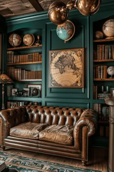 a living room with green walls and leather couches in front of bookshelves