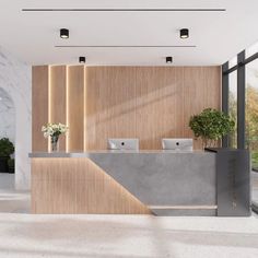 an office lobby with marble counter tops and planters on either side of the reception desk