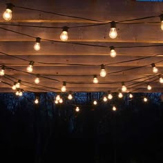 the lights are hanging from the wooden structure