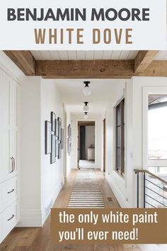 a long hallway with white paint and wooden ceilinging, the words benjam moore white dove on it