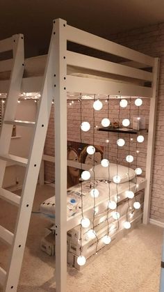 a loft bed with white lights on it