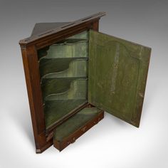 an open wooden cabinet with green paint on it