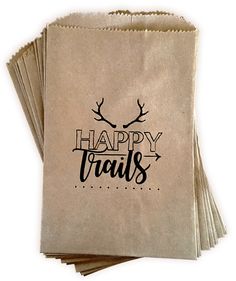 happy trails paper bags are stacked on top of each other