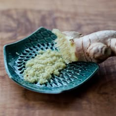 a close up of a piece of broccoli on a plate with the roots still attached