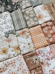 a patchwork quilt with flowers and polka dots on the top, in various colors