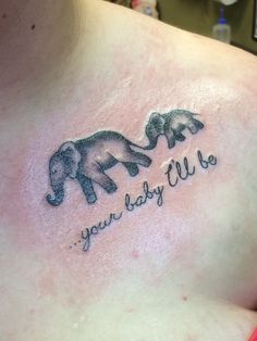 an elephant tattoo with the words you baby lie on it's chest and two elephants touching each other