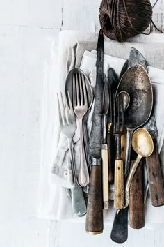 an assortment of silverware is laid out on a table