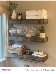 some shelves in a bathroom with towels and other items on top of them, next to a window