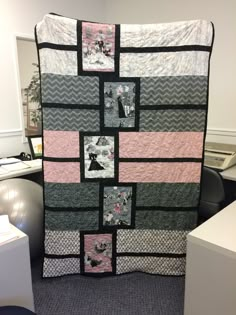 a large quilt is on display in an office