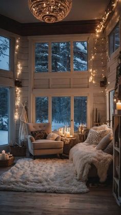 a living room filled with furniture and lots of lights hanging from the ceiling next to windows