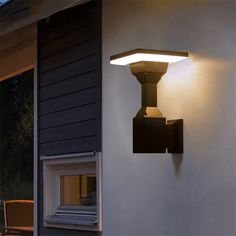 an outdoor wall light on the side of a house