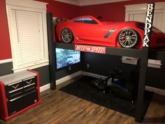 a red sports car sitting on top of a bunk bed in a boys'bedroom