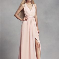 a woman in a long pink dress posing for the camera