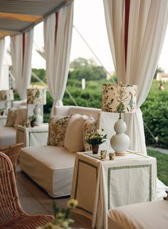 an image of a living room with white curtains on the windows and furniture in front