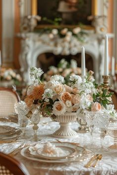 an elegant table setting with flowers and candles