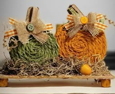 two pumpkins made out of twine and burlocks on top of hay