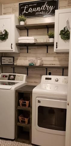 a white washer and dryer sitting in a laundry room next to each other