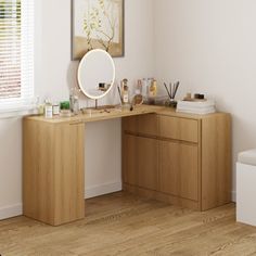 a wooden desk with a mirror and other items on it next to a white toilet