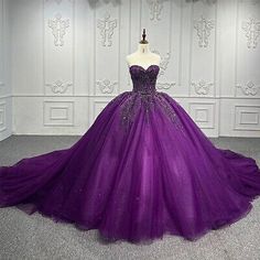 a purple ball gown on display in a room