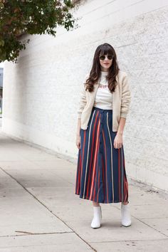 Fashion blogger wearing striped midi skirt, white booties, sherpa jacket and retro tee Retro Relaxed Skirt For Fall, Retro Winter Midi Skirt, Relaxed Striped Midi Skirt, Summer Retro Striped Skirt, Striped Relaxed Midi Skirt, Button Front Midi Skirt, Midi Skirt White, White Booties, Striped Midi Skirt