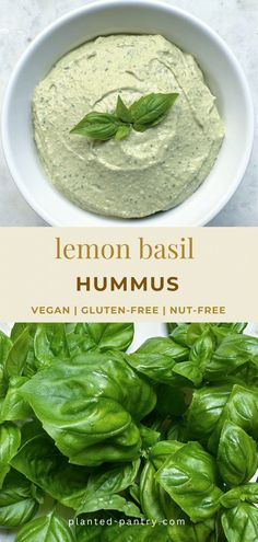 a bowl filled with green basil hummus next to a bowl full of fresh basil