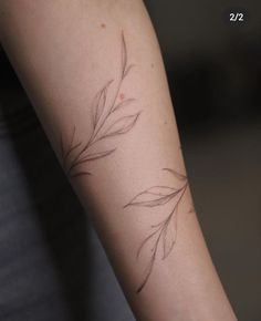 a woman's arm with a tattoo design on the left side of her arm