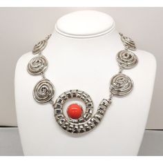 This is part of Chairish’s Costume Jewelry assortment.  1970s Modernist rhodium plated spiral links with cabochon faux-carnelian center and box clasp with a single clear round rhinestone on it necklace. Marked "U.C. Ugo Correani Made in Italy." Center:  2 inches long. Overall measures: 7 1/2 inches long by 5 1/2 inches wide. Interior circumference about 17 1/2 inches. Condition: Very good except that there is crazing to the metal coating on the clasp, which may be a problem at a later date, but Cabochon Necklace, Box Clasp, Vintage 1970s, Rhodium Plated, Costume Jewelry, 1970s, Italy