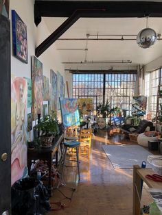 an art studio with lots of paintings on the walls