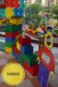 there are many legos on display in the store with balloons and other items for sale