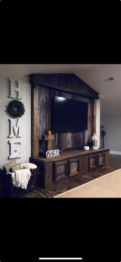 a living room with a large flat screen tv mounted to the side of a wall