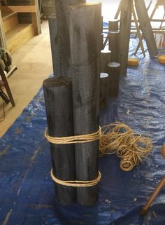 several pieces of wood tied together on a blue tarp