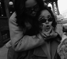 a woman is hugging another woman on the street