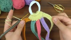 someone is crocheting together with yarn and knitting needles to make an ornament