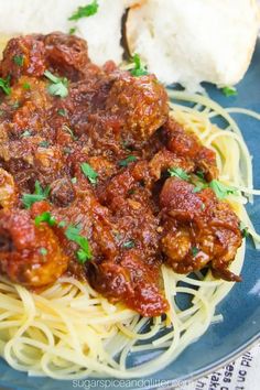 spaghetti with meat sauce and bread on a blue plate, ready to be eaten for lunch