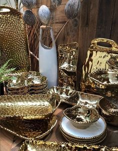 a table topped with lots of shiny dishes