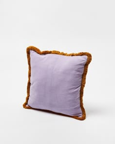 a purple and brown pillow on a white background