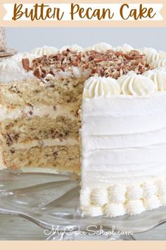 there is a cake with white frosting and pecans on the top it has one slice cut out