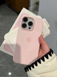 a person holding an iphone case in their hand with the cover on it's back