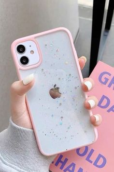 a person holding up an iphone case with glitter on the front and back cover in their hands