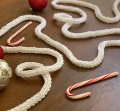 some candy canes are laying on a table next to an ornament and other decorations