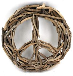 a peace sign made out of drift wood