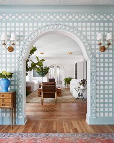 an archway leads into a living room with blue and white walls