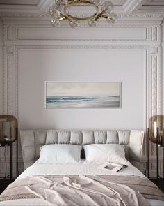 a bedroom with a bed, chandelier and painting on the wall above it