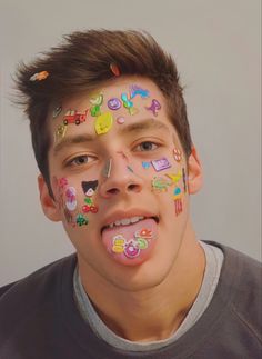 a young man with his face covered in stickers