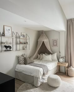 a bedroom with a canopy bed and white rugs