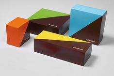 four different colored boxes sitting next to each other