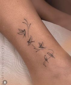 a woman's leg with three birds on it