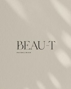 the word beaut written in black and white on a beige background with long shadows