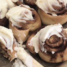 several cinnamon rolls with icing on top