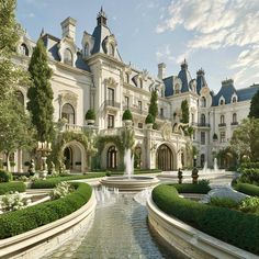 a large white mansion with a fountain in front of it and lots of greenery